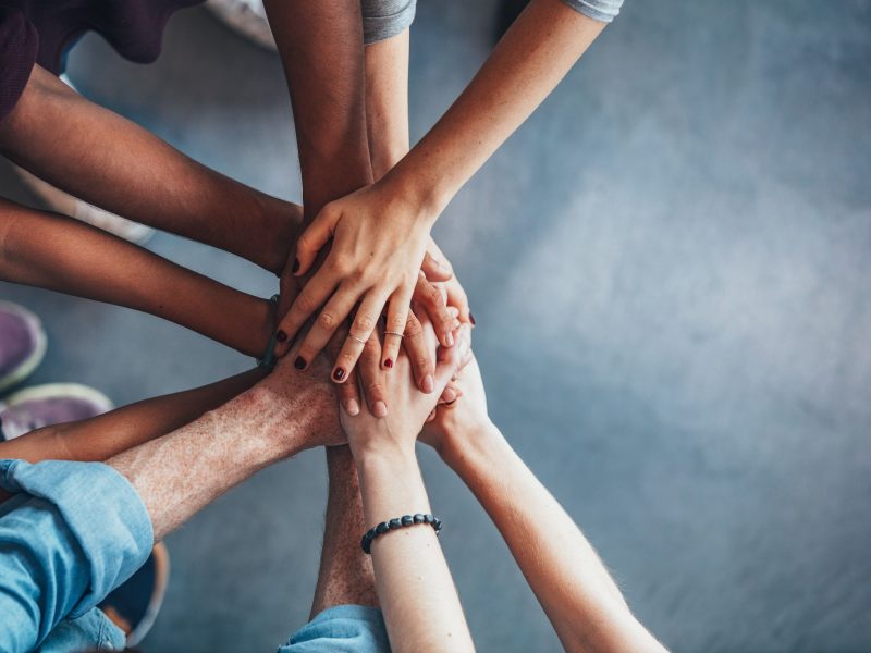 Stack of hands showing unity