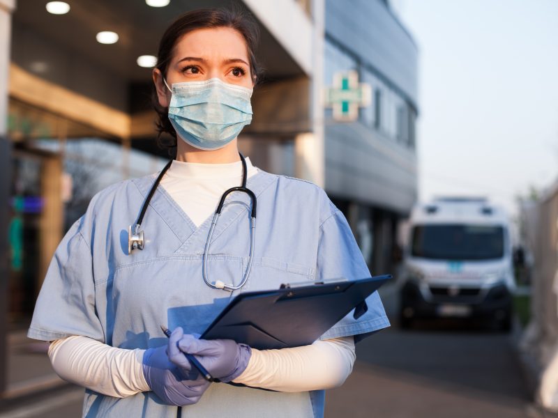 Young,Female,Ems,Key,Worker,Doctor,In,Front,Of,Healthcare