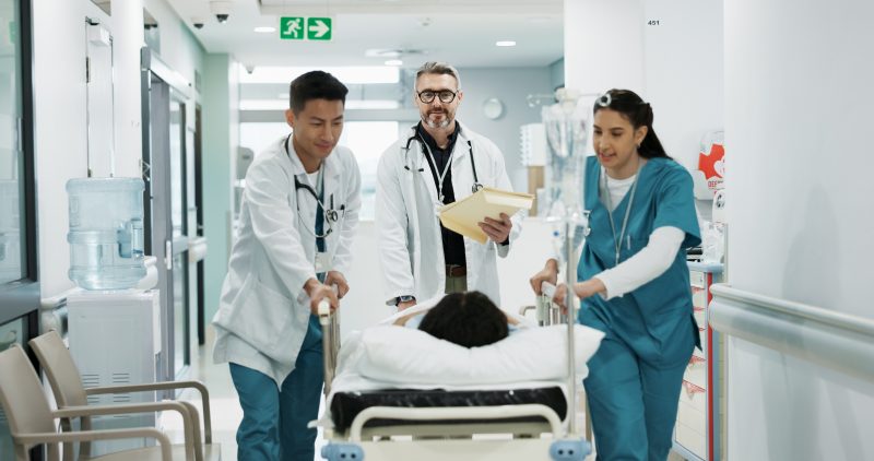 Doctors,,People,Talking,And,Push,Patient,Hospital,Bed,,Consulting,And