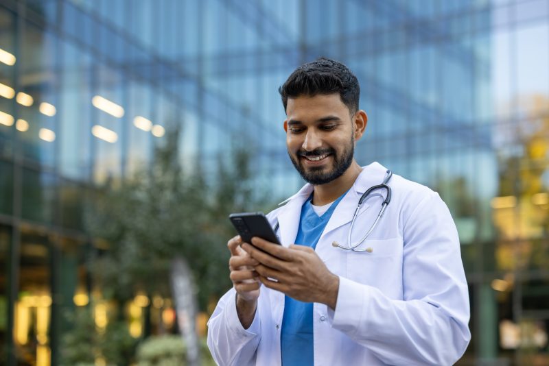 A,Smiling,Doctor,Wearing,A,White,Coat,And,Stethoscope,Checks