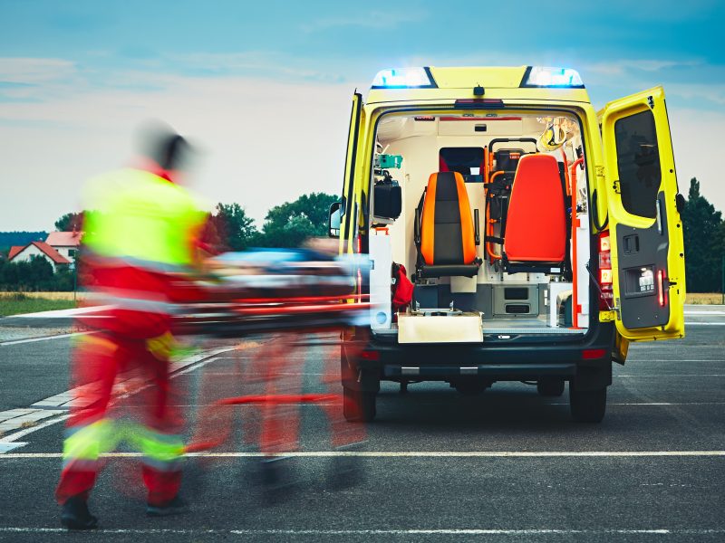 Emergency,Medical,Service.,Paramedic,Is,Pulling,Stretcher,With,Patient,To