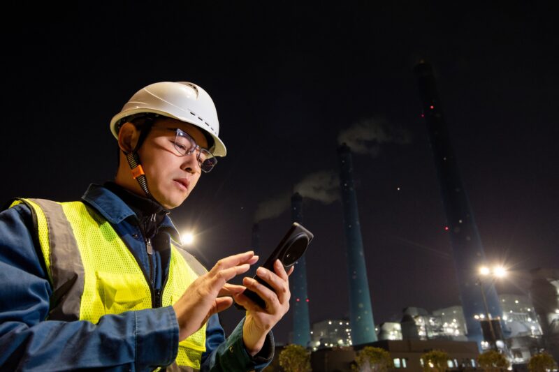 Chinese,Male,Engineer,Using,Smart,Phone,In,Power,Station