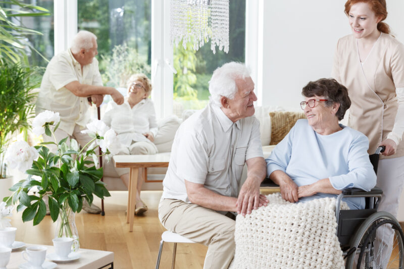 Senior,Man,Visits,His,Smiling,Wife,On,Wheelchair,At,Friendly