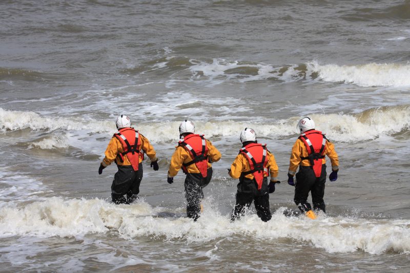 Four,Lifeboat,Crew,Walk,Out,For,A,Crew,Change,On