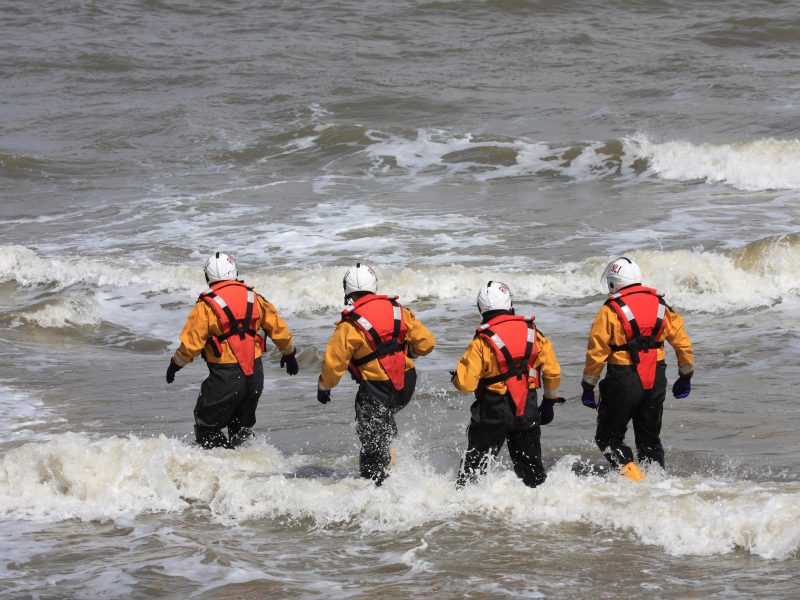 Four,Lifeboat,Crew,Walk,Out,For,A,Crew,Change,On