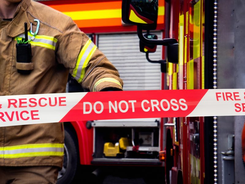 Firefighter,In,Action,At,Fire,Scene,Cordon,With,Hand,Of